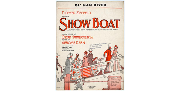 Photo of a copy of the original  sheet music and lyrics for the song “Ol’ Man River”, which Paul Robeson controversially sang in his role as Joe the Riverman, in the 1927 play Show Boat. The letters “Show Boat” appear in orange type above a group of men, women, and children bedecked in vintage hats and bonnets ascending a gangplank.