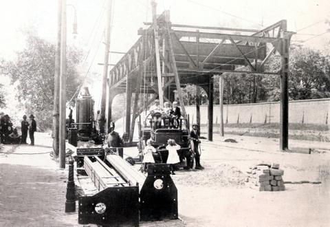 Children pose next to construction equipment near the first constructed section of the Market Elevated.