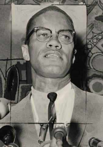 black and white photo of Malcolm X, at three microphones, head tilted upward, clean-shaven with closely cropped hair and eyeglasses, wearing a light gray-toned suit or sports coat, white shirt, and dark tie.