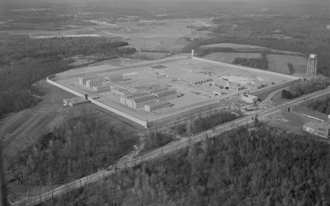 Black and white aerial photo of the prison, two separate courtyards enclosed by buildings.