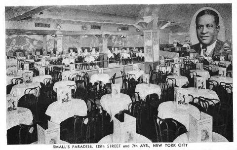 Black and white postcard of the Paradise Room, likely printed in the 1930s. Numerous tables, each with a white tablecloth, menu, and hairpin side chairs, fill up the spacious room. A photo of Ed Smalls, in coat and tie, appears in the top-right corner of the postcard.