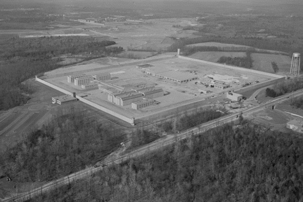 Black and white aerial photo of the prison, two separate courtyards enclosed by buildings.